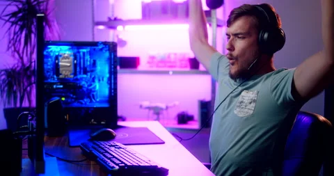 Video gamer wins while playing online video game and comunicating and celebrates Stock Footage 160561857