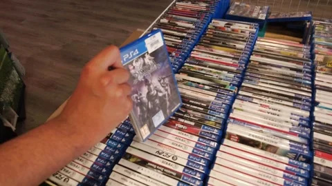 Video games Play Station 4 video cases on a store shelf. Stock Footage 345388408