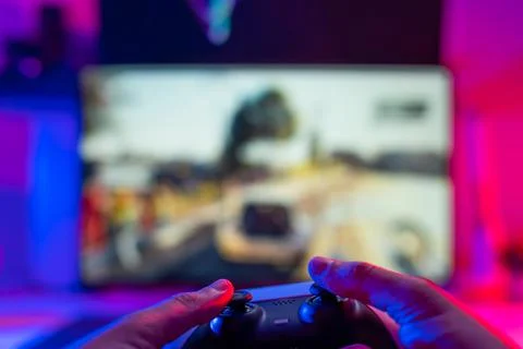 Video games. On a technological background, a joystick in the hands of a game Stock Photos