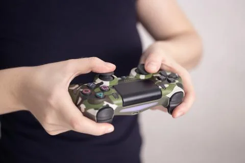 Video games wireless playing controller joystick in woman's hands Stock Photos