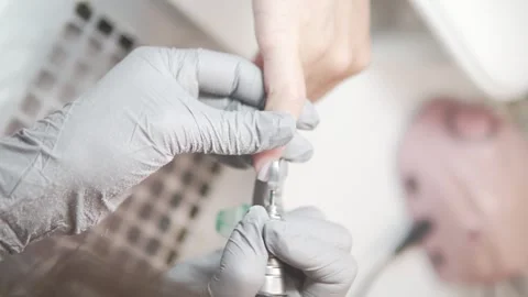 In the video, the gloved master performs the final part of the hardware manicure Stock Footage 311047200