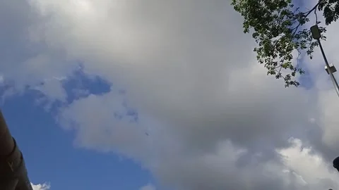 Video of Gray Clouds Moving on a Blue Sky Background and an Exsavator Working Stock Footage 309306954