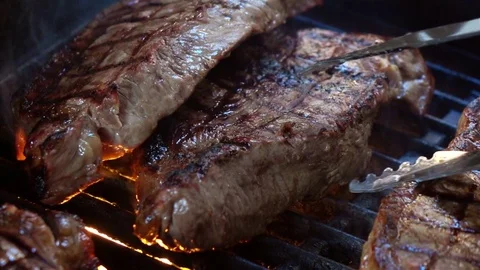 Video of grilling steaks on fire in real slow motion Stock Footage 74829914