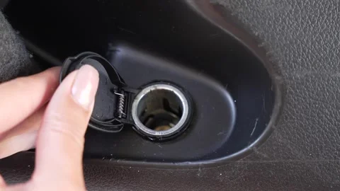 Video of a hand opening the car cigarette lighter Stock Footage 346183929