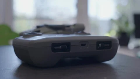 Video of a hand placing a drone remote control Stock Footage 275324078