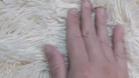 Video of hand white wool plaid background Stock Footage 244644014