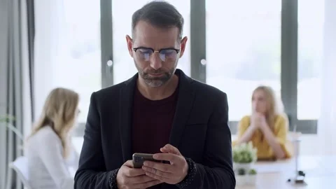 Video of handosme mature man using her mobil phone while drinking coffee. In  Video stock 161732802