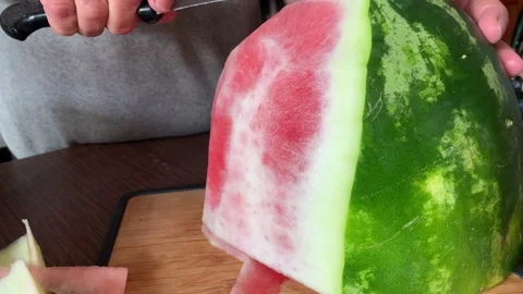 Video of hands cutting and peeling a watermelon. Food concept. Stock Footage 256047222