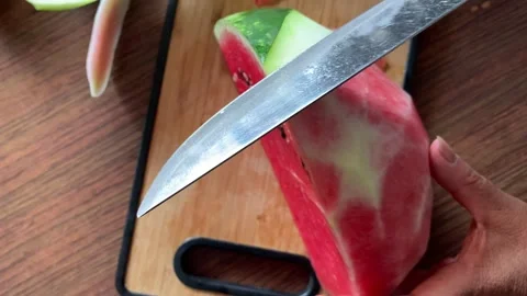 Video of hands cutting and peeling a watermelon. Food concept. Stock Footage 256047271