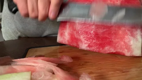 Video of hands cutting and peeling a watermelon. Food concept. Stock Footage 256047272