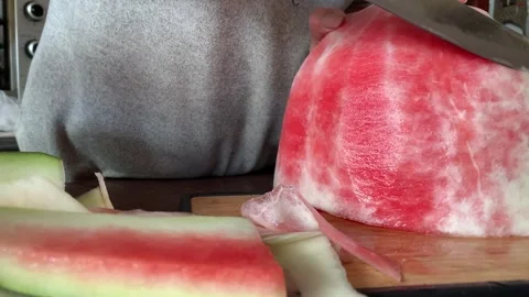 Video of hands cutting and peeling a watermelon. Food concept. Stock Footage 256047278