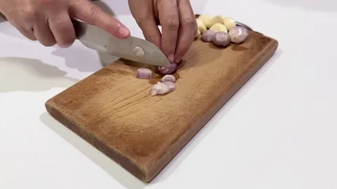 Video of hands cutting challot on a chopping board. Isolated on white background 스톡 동영상 287583494