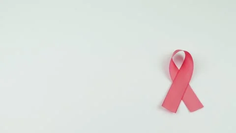 Video of Hands placing a pink Ribbon Stock Footage 231484895
