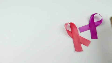 Video of Hands placing a two pink Ribbons Stock Footage 231484845