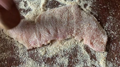 Video of hands preparing chicken milanesa. Food preparation concept. Stock Footage 256047410