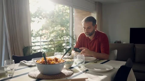 Video of handsome concentrated man using smartphone while sitting before lu.. Video stock 251890795