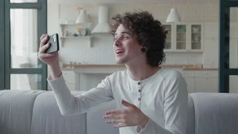 Video of a handsome young man making video call from home waving hand Stock Footage 156893273
