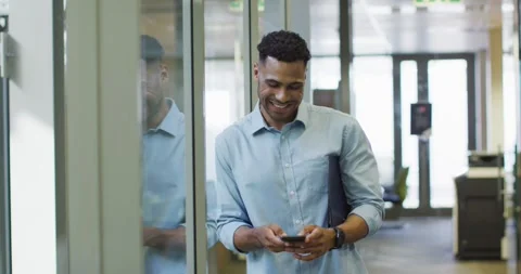 Video of happy businessman using smartphone in office Stock Footage 340008152