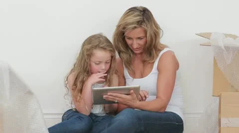 Video of happy mother and daughter using tablet computer Stock Footage