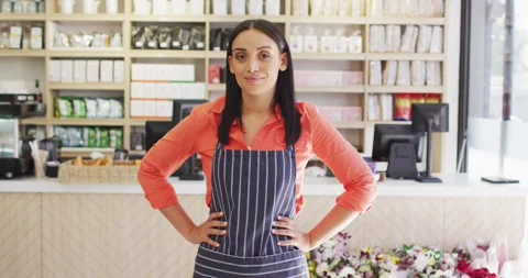 Video of happy waitress in apron standing in coffee shop 動画素材 342594233