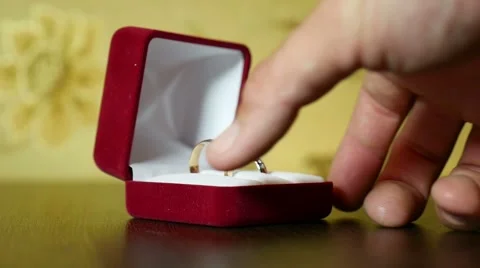 Video in her hand wedding rings in red box Stock Footage 66777859