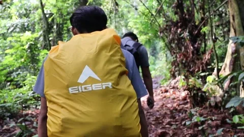 Video of Hiker Walking with Yellow Eiger Rain Cover Backpack Stock Footage 318237763