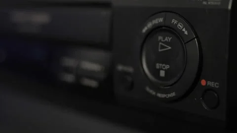 Video of a human hand inserting a video tape into a vhs player and pressing.. Stock Footage 233452437