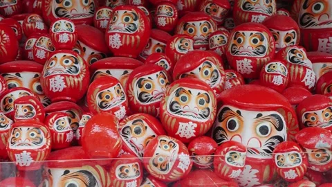A video of hundreds of red Daruma dolls displayed at Katsuoji Temple in Osaka Stock Footage 344279408
