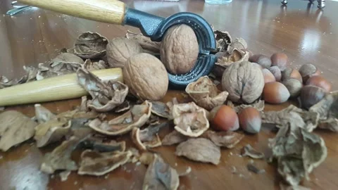 Video image of Walnut and hazelnut cracker on wooden table Stock Footage 171971932