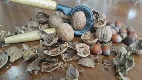 Video image of Walnut and hazelnut cracker on wooden table Stock Footage 171971982
