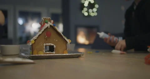 Video of Kids building ginger bread house and eating Candy, Family Christmas Vídeos de archivo 298354831