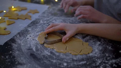 Video of kids making decorating gingerbread Christmas cookies. Family in kitchen Stock Footage 220558219