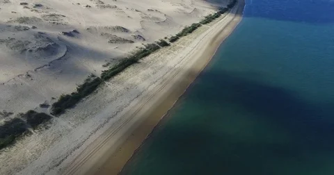 Video of the largest sand dune, blue sky and ocean. Stock Footage