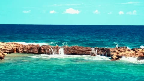 Video of lazur sea waves hitting the big stones Stock Footage 211175794