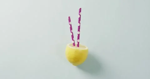 Video of lemon cut in half with straws lying on white background Stock Footage 340985983