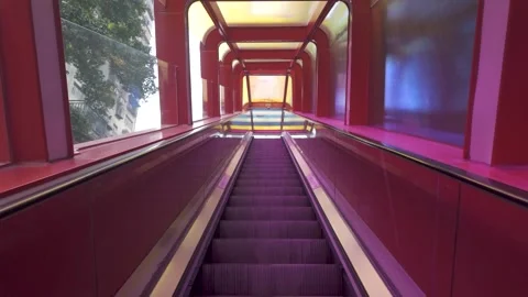 Video of long escalator ride inside red and purple tunnel at Huangguan Crown Stock Footage 324943401