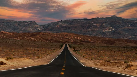 Video loop time lapse of clouds moving over empty desert highway in Death Stock Footage 346123375