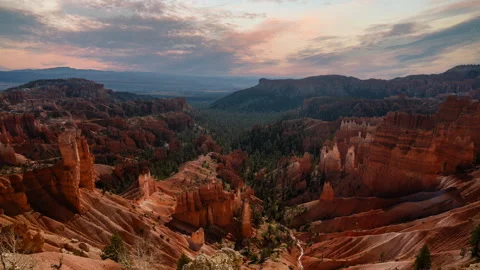 Video loop time lapse of clouds moving over the sky. Red rock hoodoos in Bryce Stock Footage 346131806