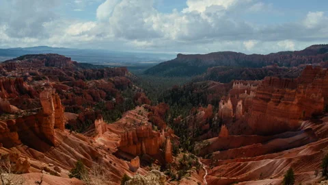 Video loop time lapse of clouds moving over the sky. Red rock hoodoos in Bryce Stock Footage 346132095