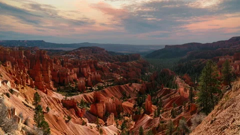 Video loop time lapse of clouds moving over the sky. Red rock hoodoos in Bryce Stock Footage 346549763