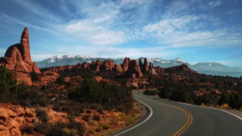 Video loop Time lapse of clouds moving over a scenic winding road in Arches Видео 348238804