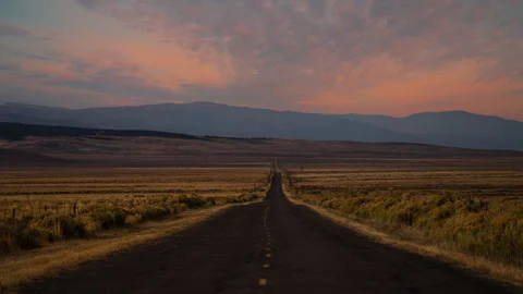 Video loop time lapse of clouds moving over empty desert highway in Death Video stock 348238833
