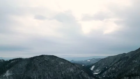 Video made with a drone moving alongside snow covered mountains Stock Footage 239638890