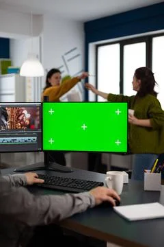 Video maker editing movie at pc with green screen Stock Photos