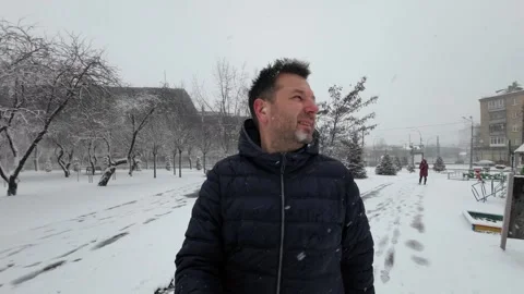 A Video of a Man in a Dark Blue Jacket and Snowfall Video stock 249105523