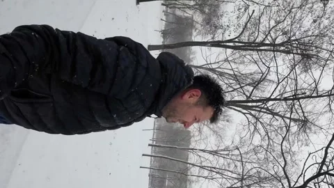 A Video of a Man in a Dark Blue Jacket and Snowfall Stock-Footage 249671469