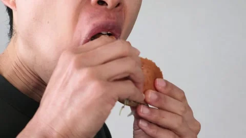 Video of a man eating a hamburger Stock Footage 323492923