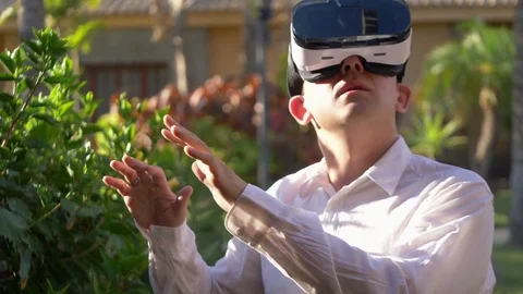 Video of man exploring virtual reality in tropical resort in 4k slow motion Stock Footage 80225299