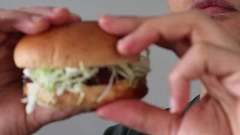 Video of a man holding a hamburger Stock Footage 323493133