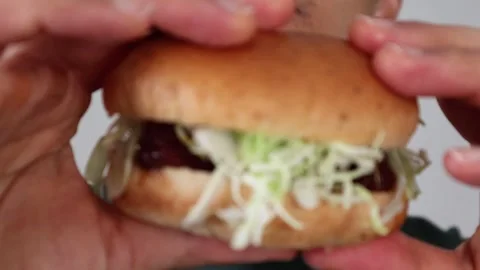 Video of a man holding a hamburger Stock Footage 323493134
